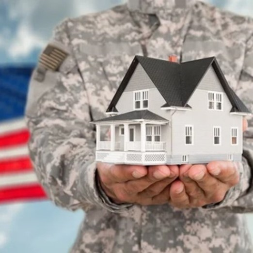 Veteran holding a model house