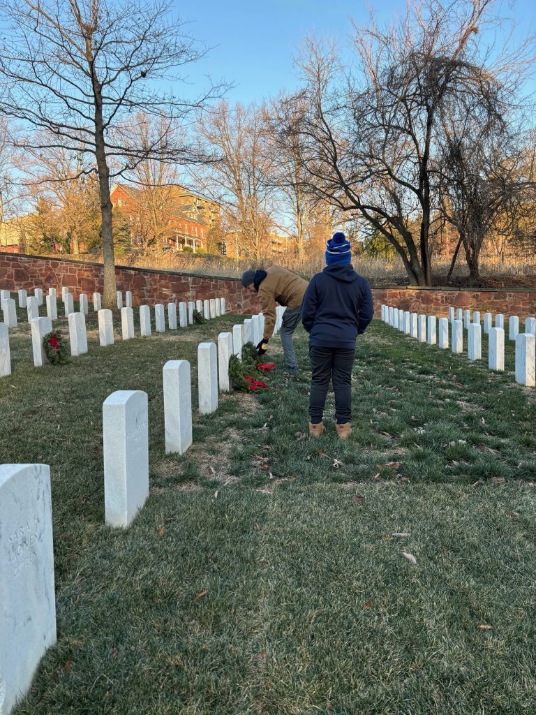 Person reading gravestone